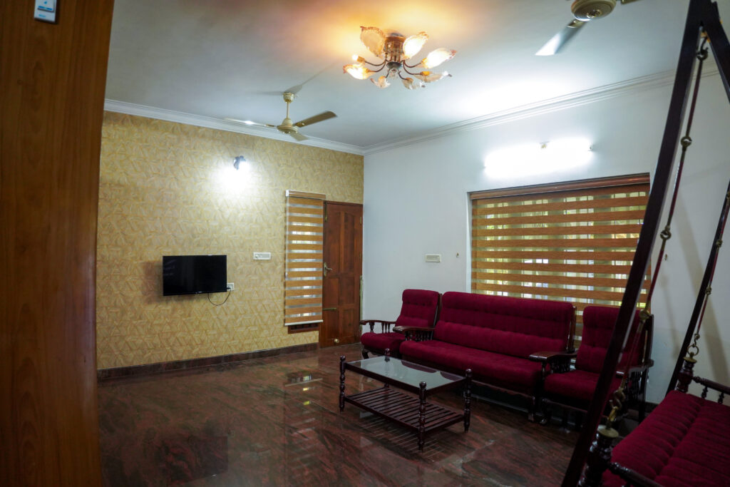 Fully furnished living room with sofa and TV