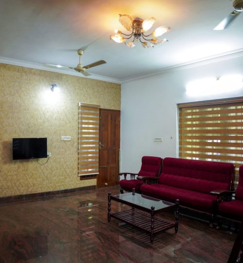 Gallery Fully furnished living room with sofa and TV at homestay family stay kochi