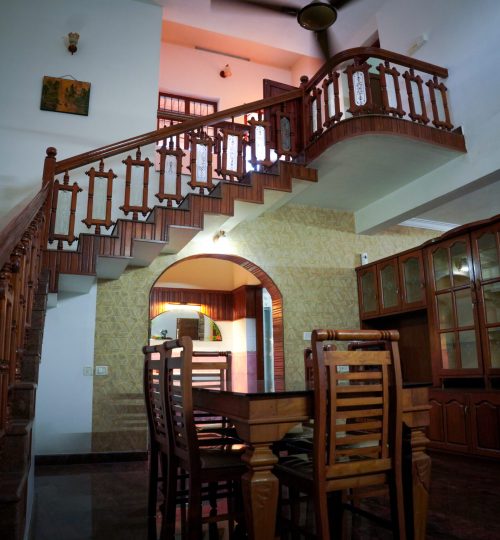 Gallery Wooden staircase and dining area at home stay kochi